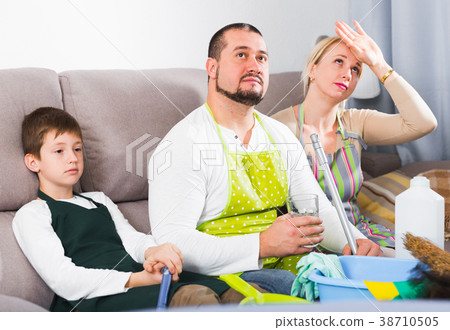 Tired family with cleaning equipment Tired family with cleaning equipment 38710505