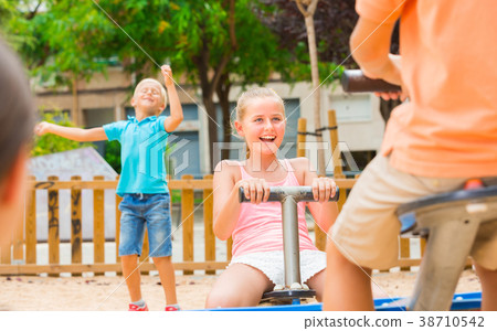 Children are teetering on the swing Children are teetering on the swing 38710542