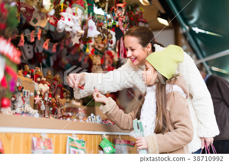 girl with mom buying decorations girl with mom buying decorations 38710992