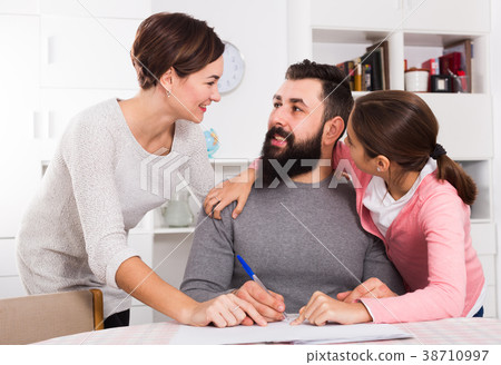 Parents signing property papers 38710997