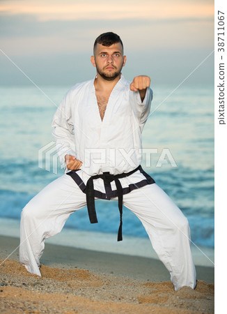 Man doing karate at ocean quay Man doing karate at ocean quay 38711067