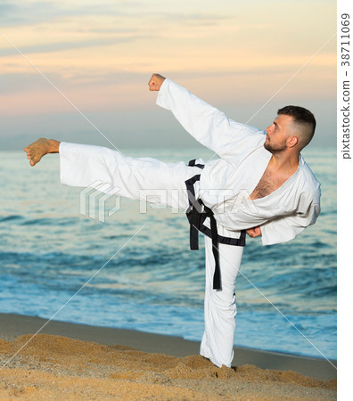 Male doing karate at ocean quay 38711069