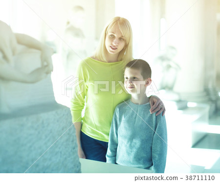 mother and son exploring old statues in museum 38711110