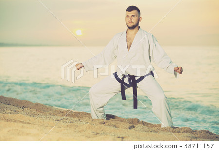 Brunette male doing karate at ocean quay Brunette male doing karate at ocean quay 38711157