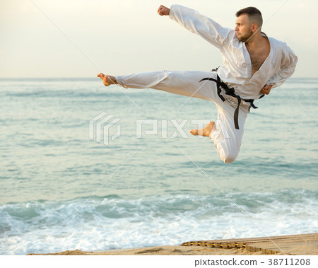 Laughing male practising karate kata poses 38711208