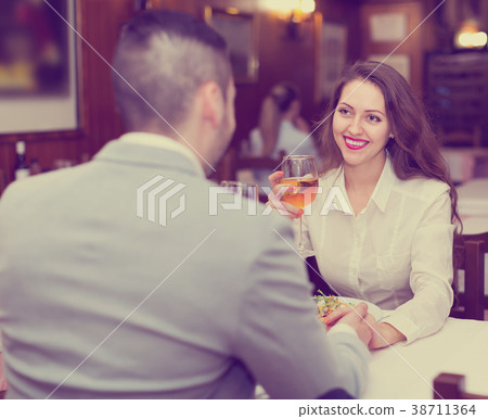 Couple having dinner in restaurant 38711364
