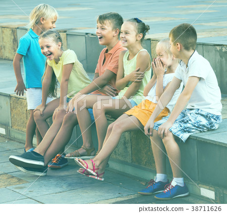 cheerful children playing charades outdoors 38711626