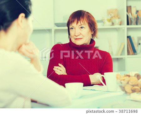 Portrait of sad mature woman talking with daughter 38711698