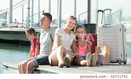 Parents with two kids travelling together Parents with two kids travelling together 38711742
