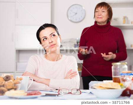 Mature female talking with young sad daughter Mature female talking with young sad daughter 38711766