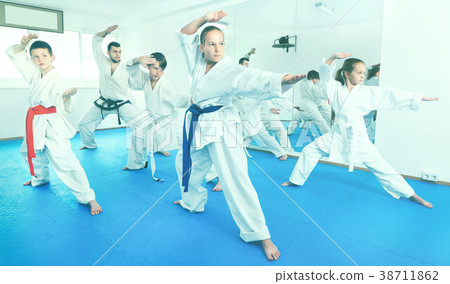Children trying martial moves in karate class Children trying martial moves in karate class 38711862