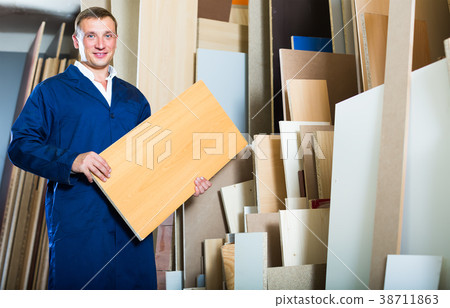 smiling workman standing with plywood pieces smiling workman standing with plywood pieces 38711863