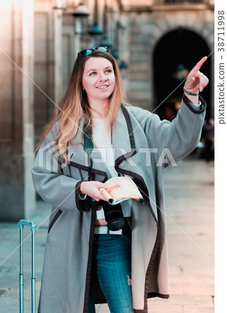 Woman having pamphlet and looking for her route 38711998