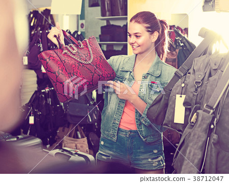 teenage girl picking handbag teenage girl picking handbag 38712047