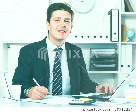 Businessman in office clothes filling up documents Businessman in office clothes filling up documents 38712234