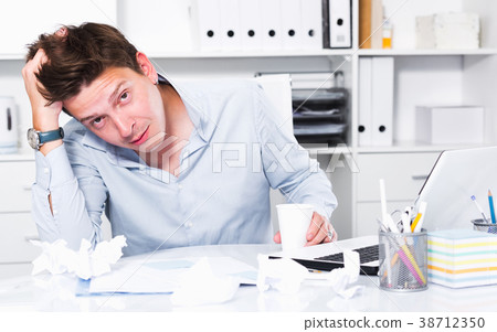 Businessman worrying at office 38712350