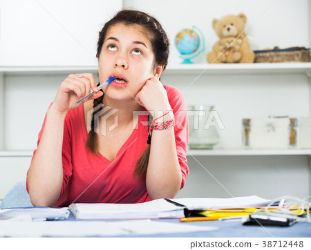 Girl doing homework 38712448