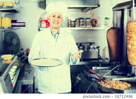 man chef serving fresh kebab 38712486