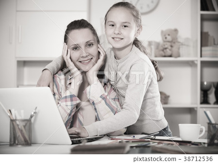 Smiling schoolgirl and young mother Smiling schoolgirl and young mother 38712536
