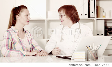 Adult female doctor leading medical appointment Adult female doctor leading medical appointment 38712552
