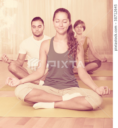 Group having yoga class in sport club Group having yoga class in sport club 38712645