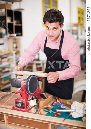 Craftsman working on woodworking machine Craftsman working on woodworking machine 38712684