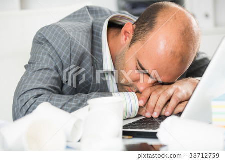 Young sad man tired of working and sleeping Young sad man tired of working and sleeping 38712759