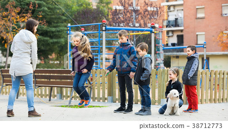 Children playing rubber band jumping game and laughing 38712773