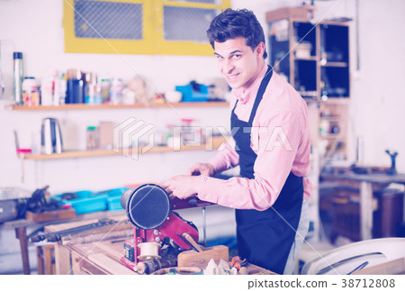 Carpenter working on manual lathe 38712808