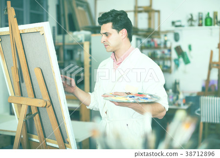 Male artist drawing in studio Male artist drawing in studio 38712896