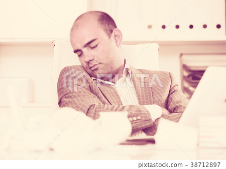 Young sad man tired of working and sleeping 38712897