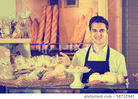 Male baker at bakery . 38712945