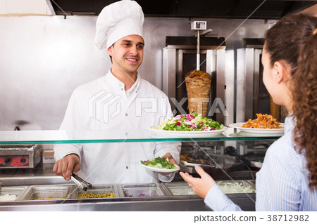 Male worker serving customer 38712982