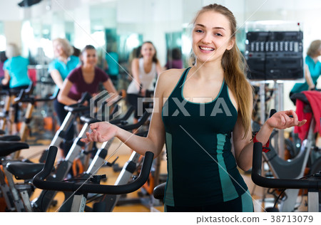 Females cycling in sport club . 38713079