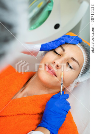 Female doctor doing beauty injection to young woman client Female doctor doing beauty injection to young woman client 38713138