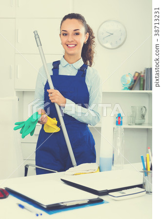 Adult woman in uniform cleaning in office 38713231