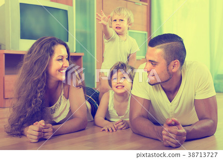 Happy family of four at home Happy family of four at home 38713727