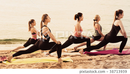 Happy sporty women practicing yoga positions 38713939