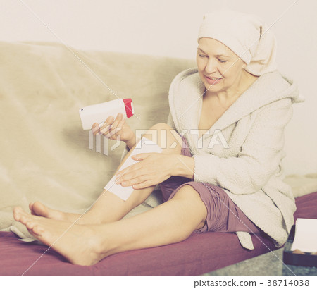 Woman doing body hair removal Woman doing body hair removal 38714038