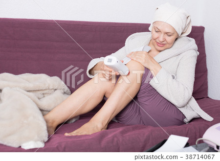 Woman doing body hair removal Woman doing body hair removal 38714067
