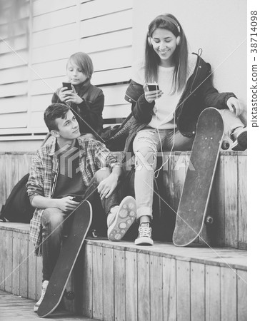 Three teenagers with smartphones 38714098