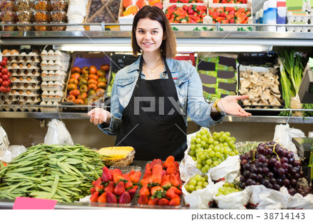 Smiling girl seller is showing assortment Smiling girl seller is showing assortment 38714143