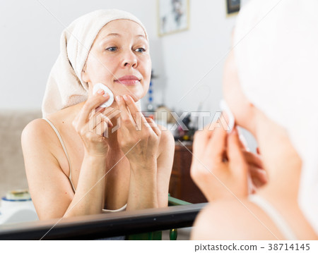 Woman cleaning face Woman cleaning face 38714145