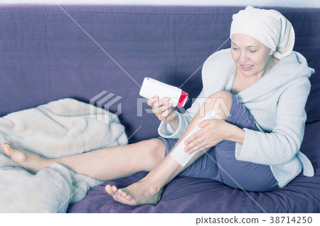 Woman doing body hair removal Woman doing body hair removal 38714250
