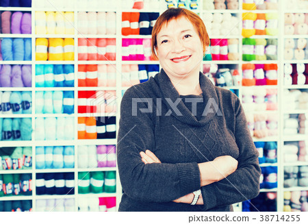 Closeup portrait of smiling mature female in shop 38714255