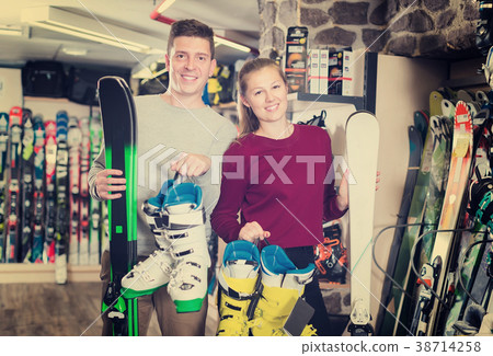 girl and man are satisfied of their choice of ski equipment girl and man are satisfied of their choice of ski equipment 38714258