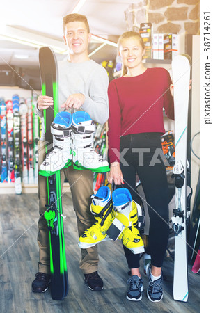 girlfriend and man are satisfied of choice of ski and boots girlfriend and man are satisfied of choice of ski and boots 38714261