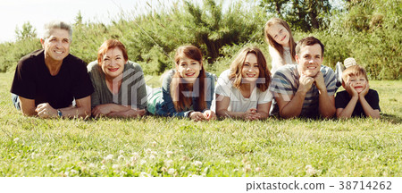 Happy family taking photos on the lawn 38714262