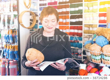 Mature woman in yarn shop Mature woman in yarn shop 38714286