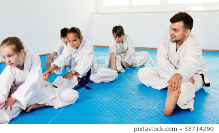 Children getting ready and stretching for karate Children getting ready and stretching for karate 38714290